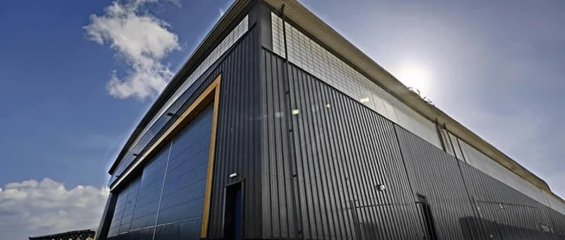 Exterior of a large hangar building on a secure site
